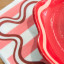 Tavola Wave Biodegradable Paper Napkins, Pack of 25 pink ombre under plate