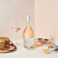 Whispering Winds Rosï¿½ in Gift Box on the table with a glass