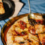 Kumquat & Co Truffle Chilli Crunch, 200ml being added to pizza