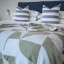Aranda Olive White Amanda Throw, 200cm x 230cm on a bed