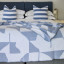 Aranda Overcast Sky White Amanda Throw, 200cm x 230cm on a bed