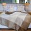 Aranda Cobblestone Coffee Top Suede Throw, 200cm x 230cm on a bed