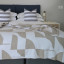 Aranda Cobblestone White Amanda Throw, 200cm x 230cm on a bed