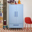 Popstrukt Sprinkles Double Locker - Blueberry Splash next to a chair