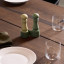 Crushgrind Mini Grinder Set, Parsley/Sage on the table with a plate and a glass