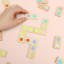 Suck UK Mello Dot to Dot Dominoes Game on the table showing scale