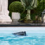 Aiper Scuba X1 Pro Max Robotic Pool Cleaner on thw surface of the pool