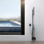 Aiper Pilot X1 Handheld Pool Vacuum placed in storage against a wall