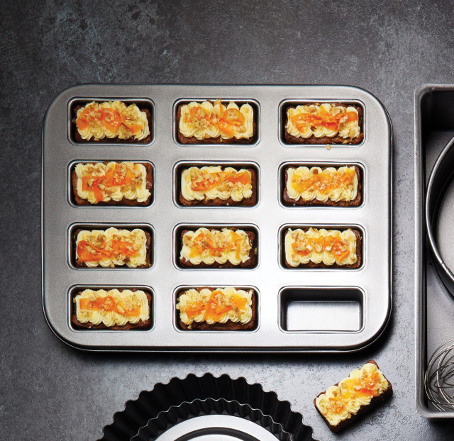 Lifestyle image of MasterClass 12 Hole Non Stick Mini Loaf Pan with Loose Bases