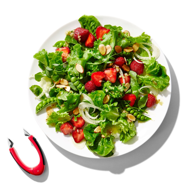 OXO Good Grips Strawberry Huller next to a salad with strawberries