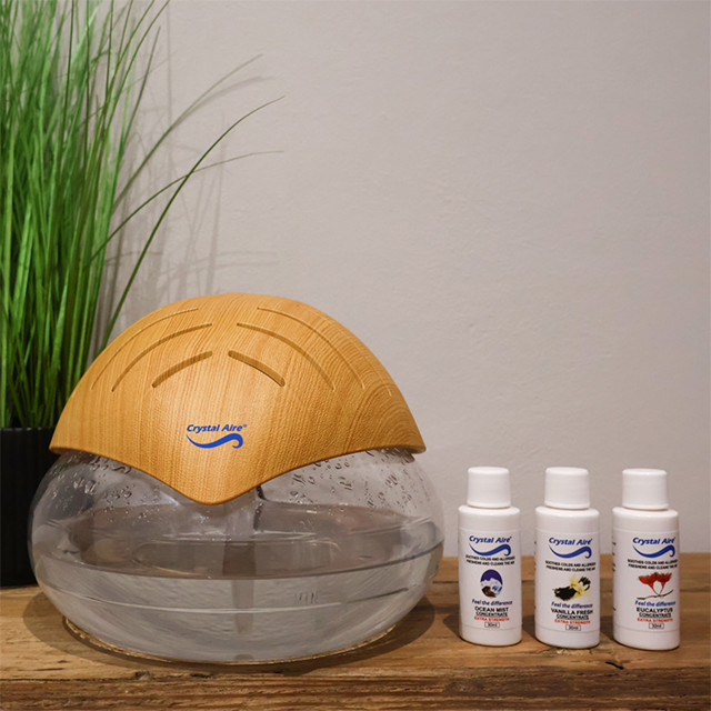 Crystal Aire Standard Air Purifier with Natural Lid on the table with concentrate