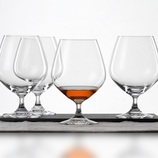 Spiegelau Lead-Free Crystal Vino Grande Cognac Glasses, Set of 4 on the table with whiskey in one glass