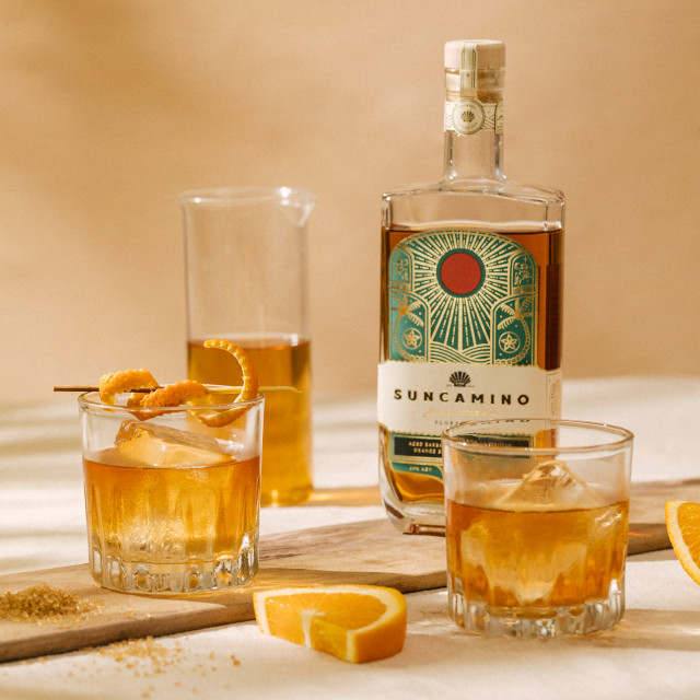 Suncamino Floral Rum, 500ml with glasses on the table