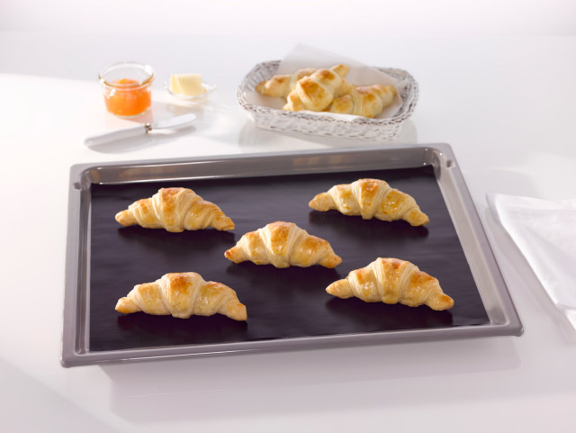 NoStik Reusable Baking Liner, on tray with croissants