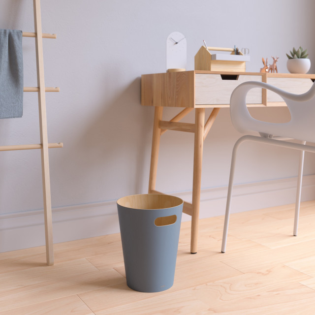 Umbra Woodrow Two-Tone Plywood Bin, 7.5L - Slate Blue next to a desk