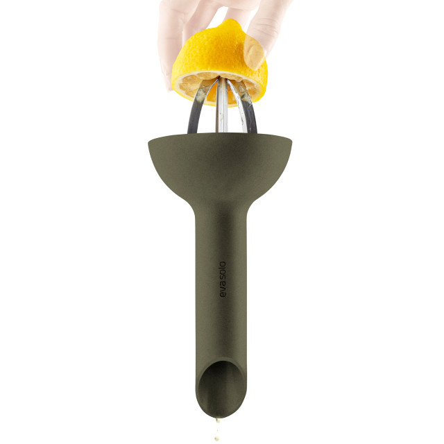Eva Solo Green Tool Citrus Press with a lemon