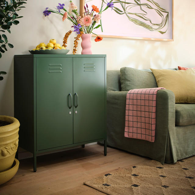 Popstrukt Sugar Cube Storage Cabinet - Dark Olive next to a couch