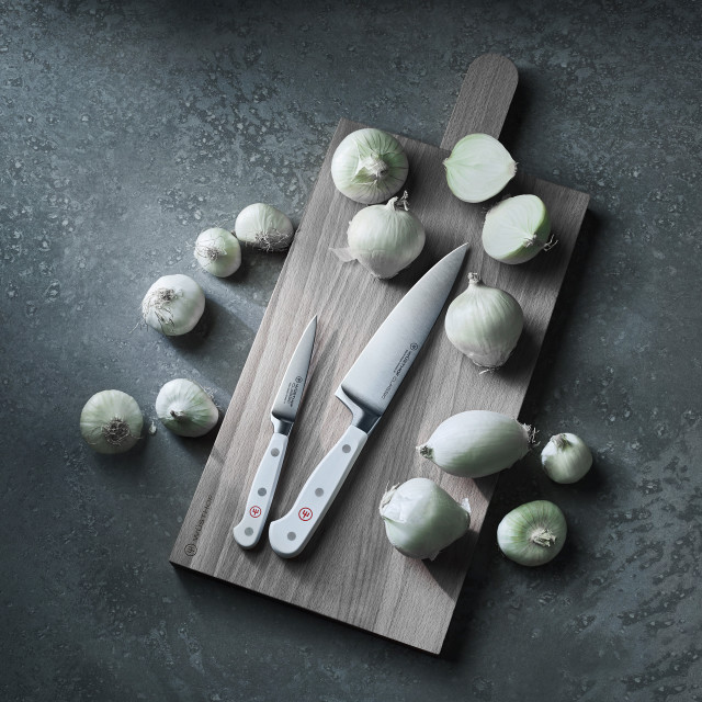WuÌˆsthof CLASSIC WHITE Paring Knife, 9cm on a chopping board with vegetables 