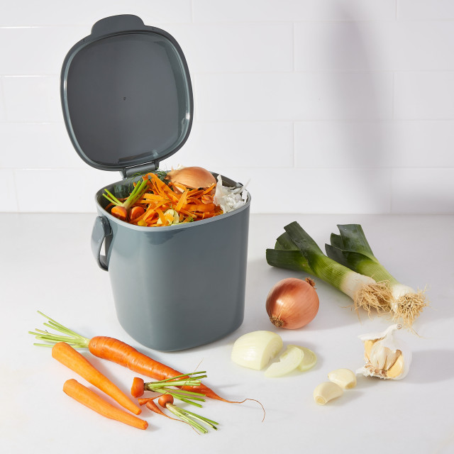 Filled OXO Good Grips Easy-Clean Compost Bin Charcoal - 2.83 L next to vegetables