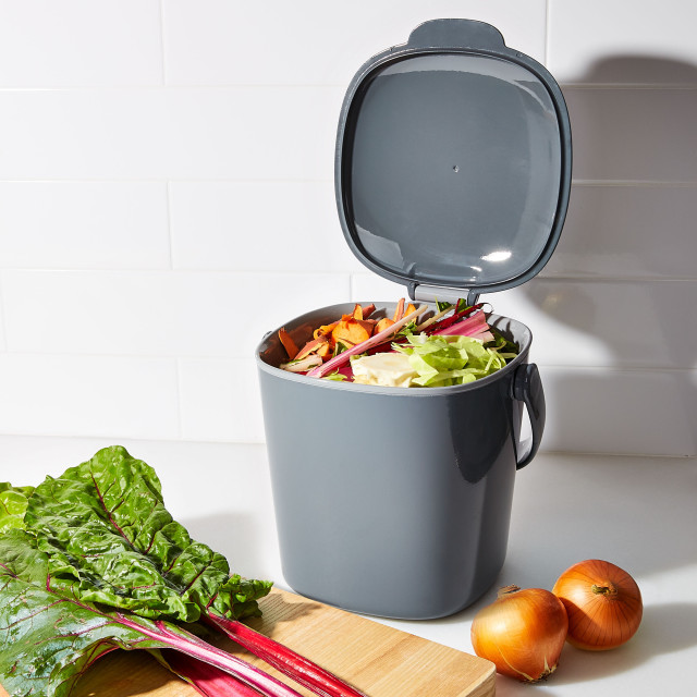 Filled OXO Good Grips Easy-Clean Compost Bin Charcoal - 2.83 L next to vegetables