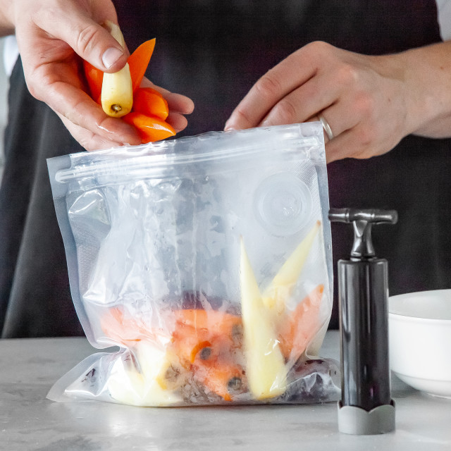 MasterClass Food Vacuum Sealer with 4 Reusable Polyethylene Food Bags in use