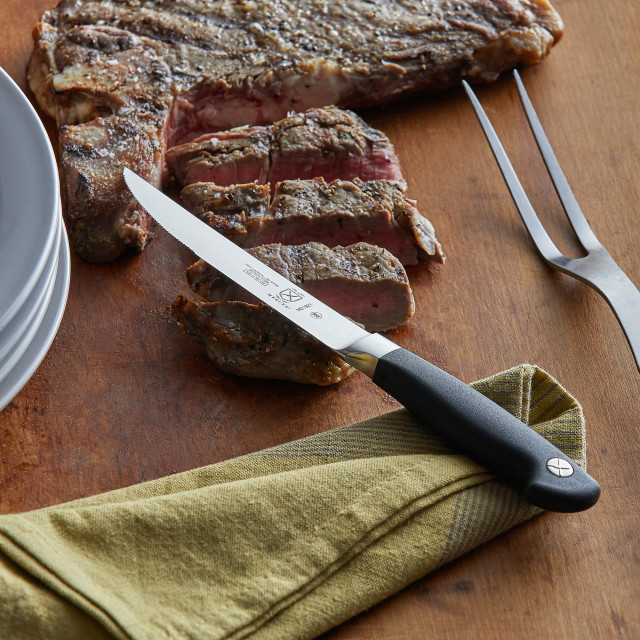 Mercer Culinary Genesis Serrated Steak Knife, 13cm in use
