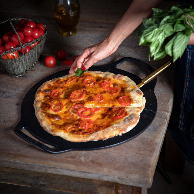 Victoria Seasoned Cast Iron Pizza Pan with Helper Handles, 38cm in use
