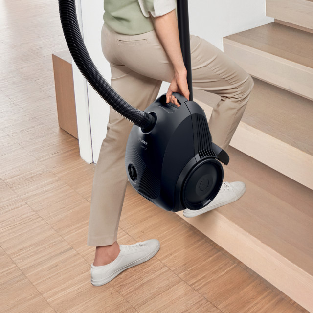 Bosch 600W Bagged Vacuum being carried