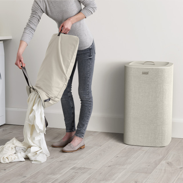 Joseph Joseph Tota 60L Laundry Separation Basket - Ecru removing laundry from the basket