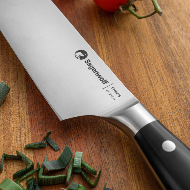 Sagenwolf Performance Chef's Knife, 21cm close up of the blade and handle on a wooden board with sliced chives