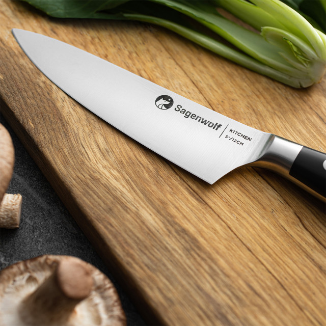 Sagenwolf Performance Kitchen Knife, 12cm on a wooden board with Sliced mushrooms and bok choy