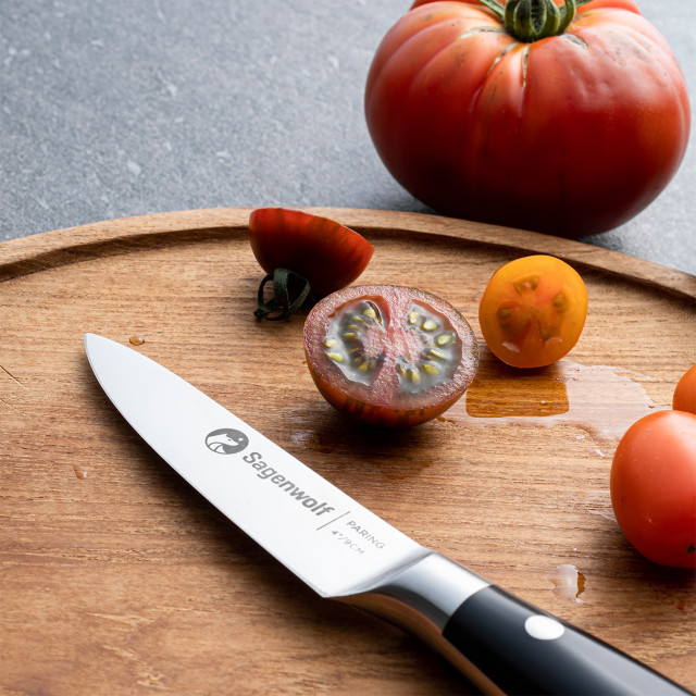 Sagenwolf Performance Paring Knife, 9cm on a wooden board with sliced tomatoes