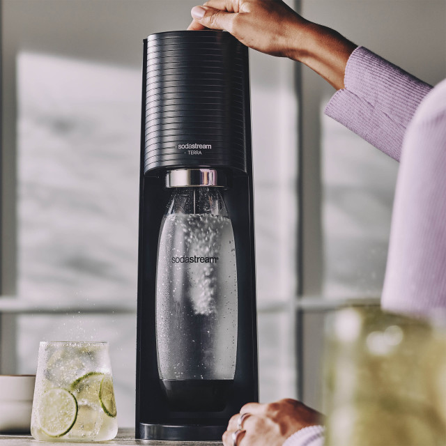 Sodastream Terra Sparkling Water Maker - Black pressing the carbonating button 