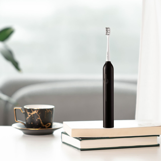 Usmile Sonic Electric Toothbrush P1 - Black on the table