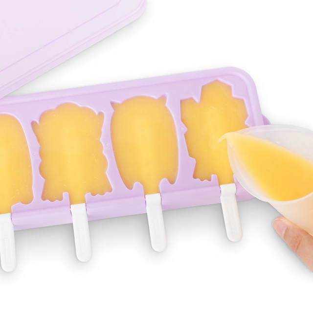 Zoku Monsters Ice Pop Mold pouring mango juice