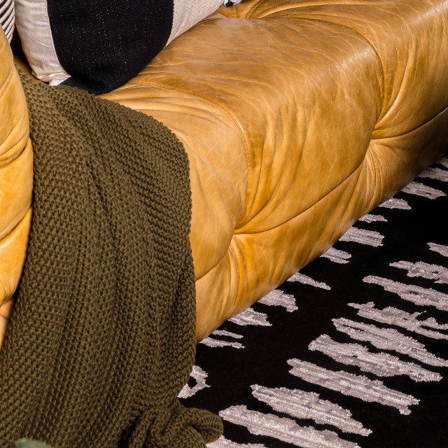 Thread Office Knitted Cotton Throw - Olive on the couch