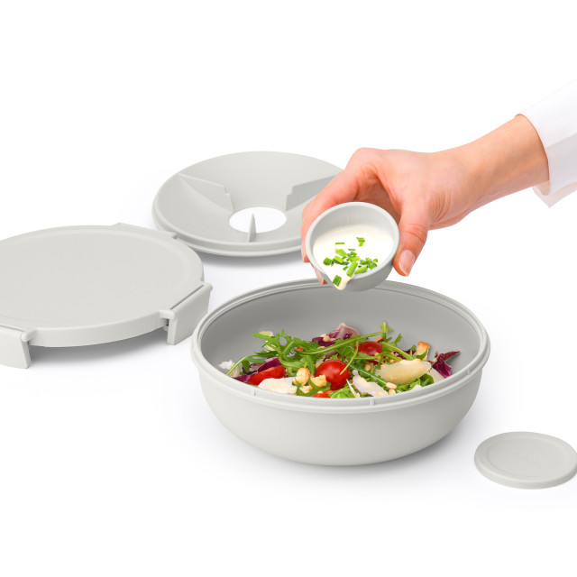 Brabantia Make & Take Salad Bowl, 1.3L - Light Grey with some salad sauce poured in the bowl