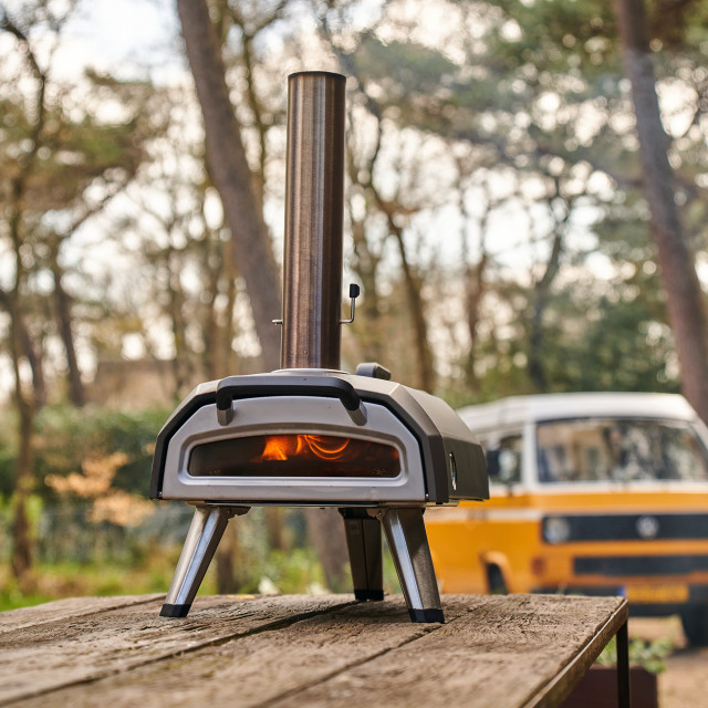 Ooni Karu 12G Wood & Charcoal Fired Pizza Oven on table outside