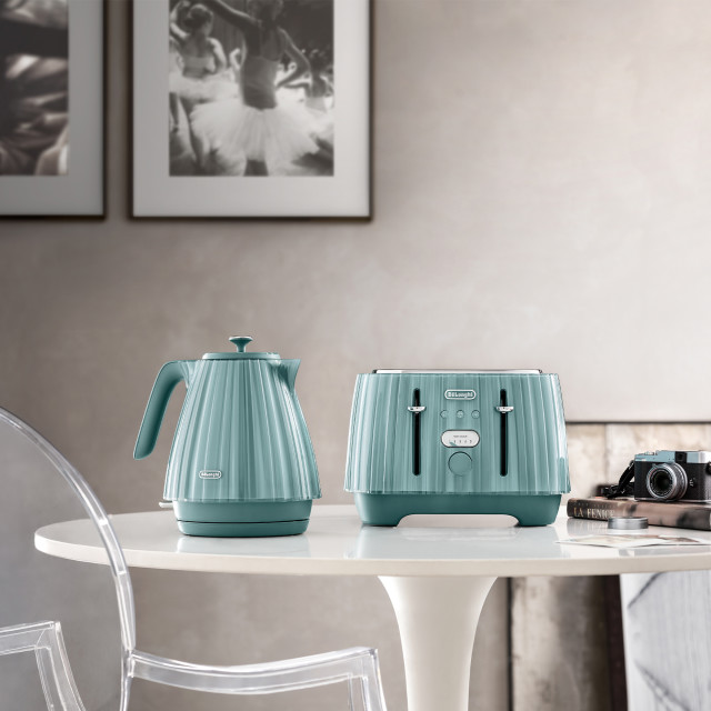 DeLonghi Ballerina Cordless Kettle, 1.7L - Laguna Green with a toaster on the table
