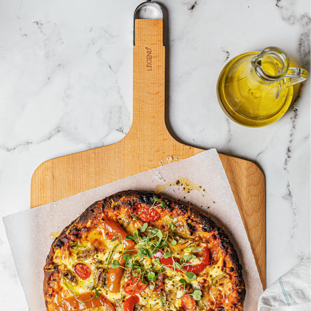 Legend Premium Beechwood Pizza Board on the table with pizza