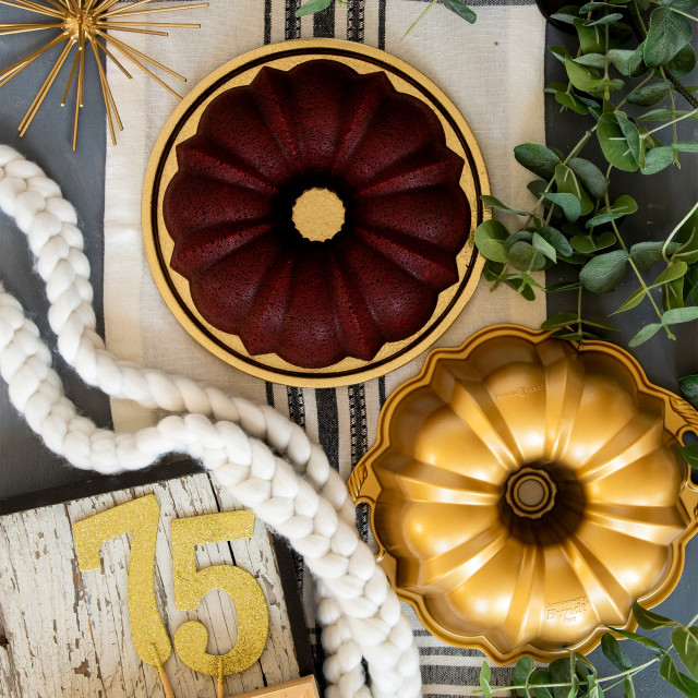 Nordic Ware Anniversary Bundt Pan, 12 Cup on the table with a cake