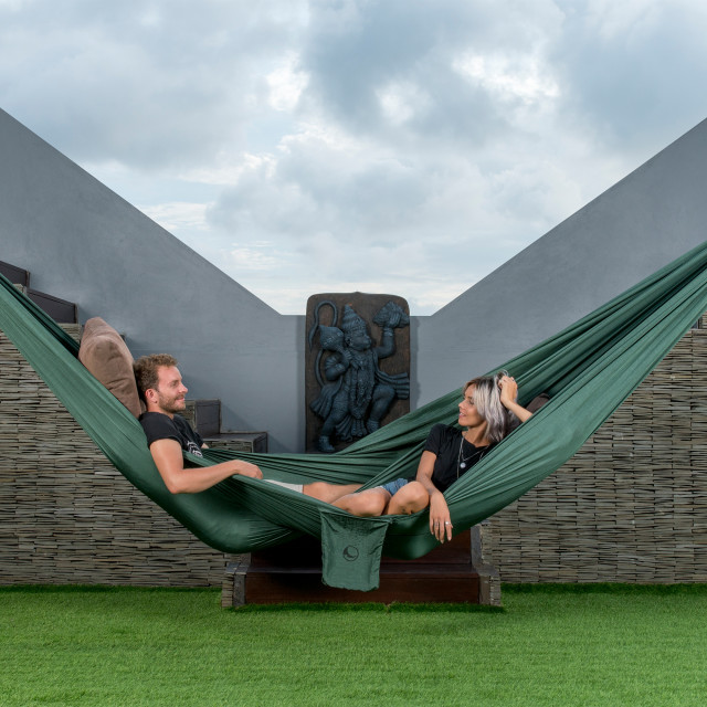 Ticket To The Moon Large Home Hammock - Sage Green hanging on a lawn wall
