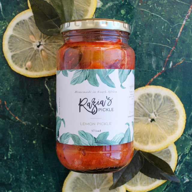 Razias Pickle Medium Heat Lemon Pickle, 375ml with lemon slices on the table