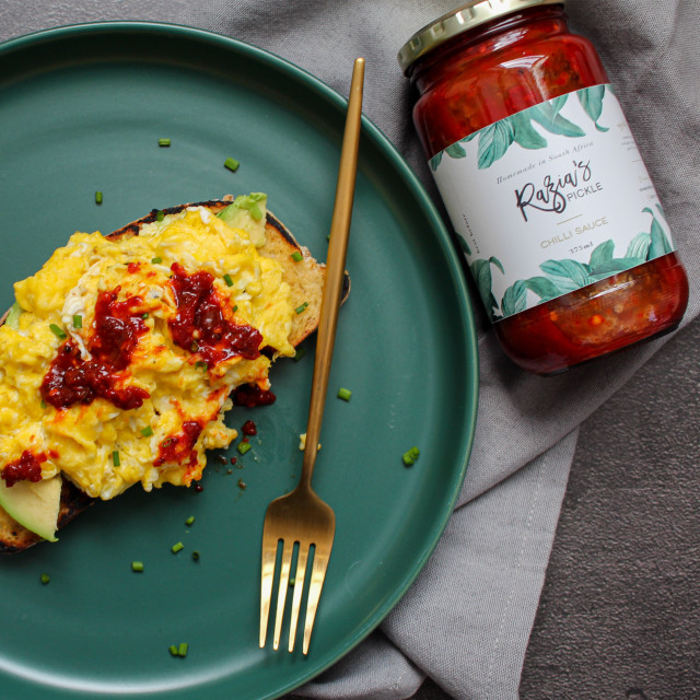 Razias Pickle  Medium Chilli Sauce, 375ml with food on the table
