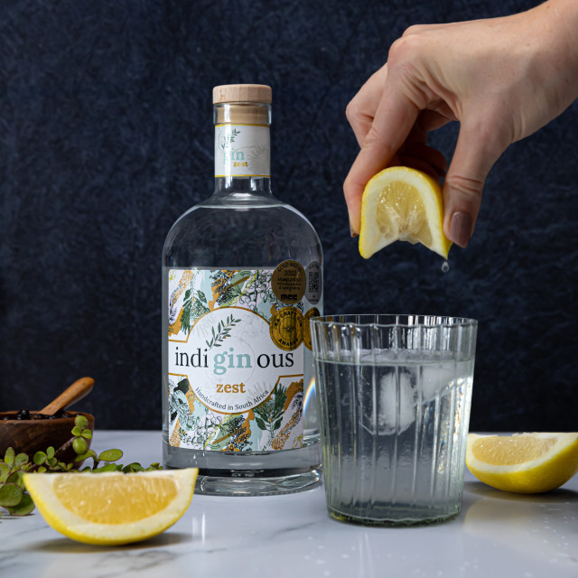 IndiGINous Zest Gin, 750ml - Lifestyle with lemon being squeezed