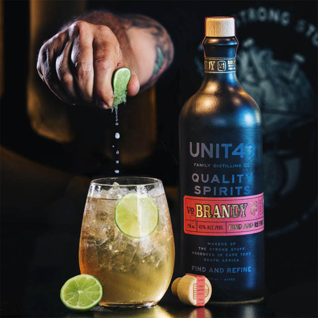 Unit 43 Distilling Company VO Brandy, 750ml lemon being squeezed into a glass of poured brandy