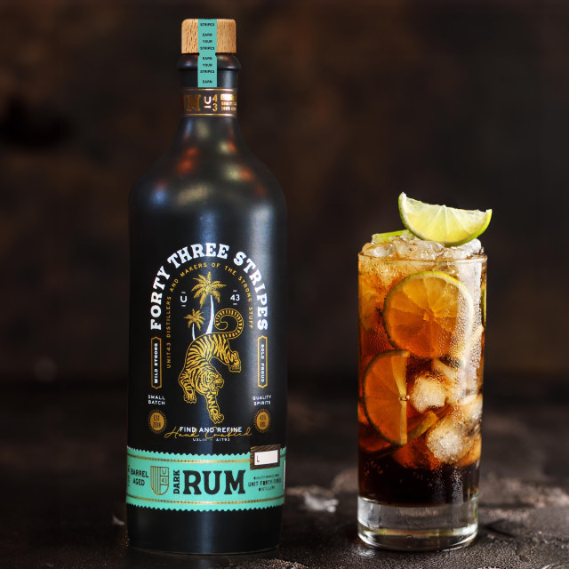 Unit 43 Distilling Company Forty Three Stripes Dark Rum, 750ml with a glass of run