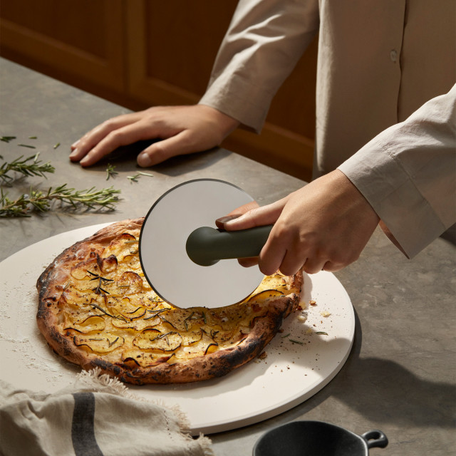 Eva Solo Green Tools Pizza Wheel on the table cutting pizza