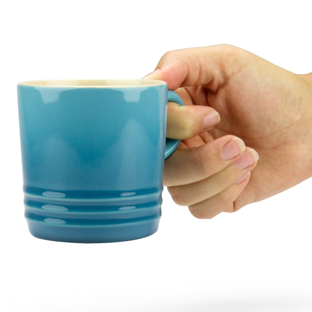 Le Creuset Stoneware Cappuccino Mug, 200ml - Caribbean Blue held