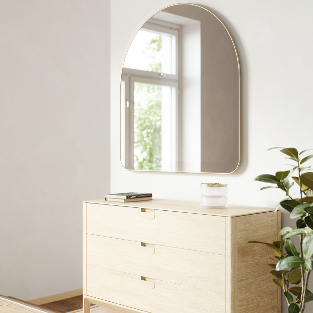 Umbra Hubba Arched Mirror - Brass In A Bedroom Setting